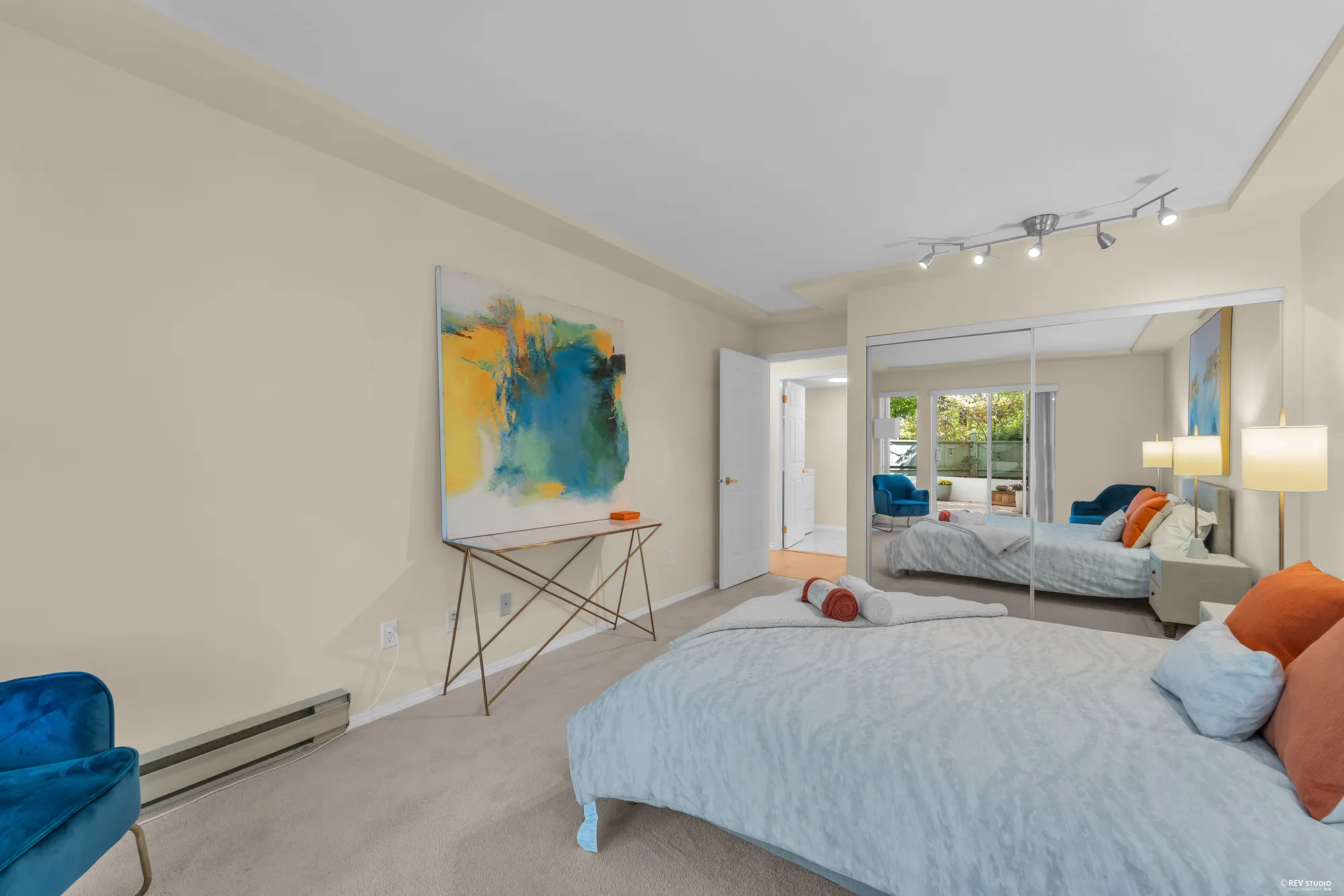 The bedroom's mirrored closet and window