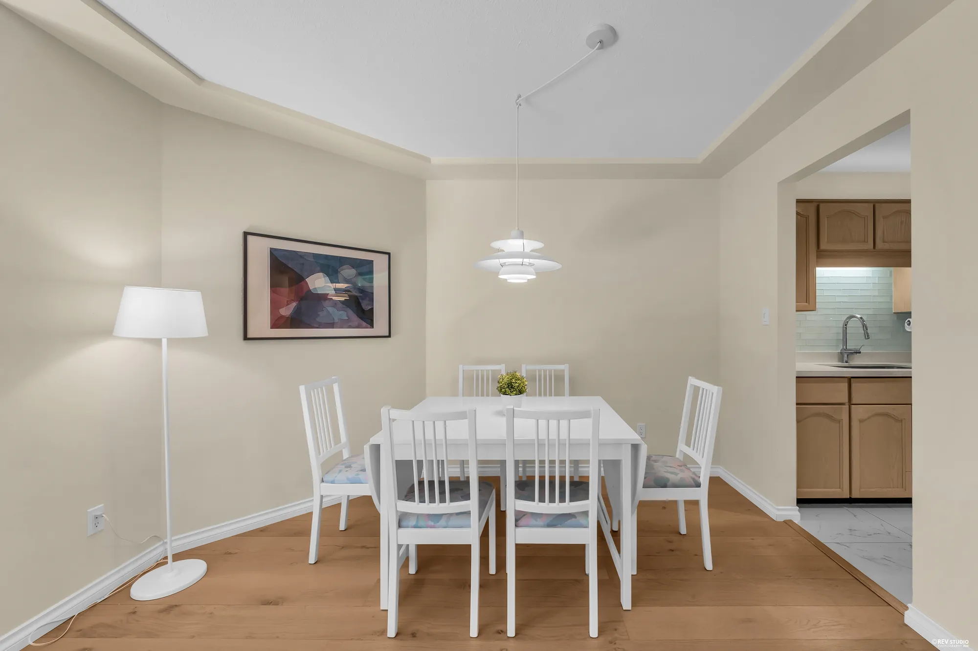 The dining area under the PH pendant, with the kitchen pass-through