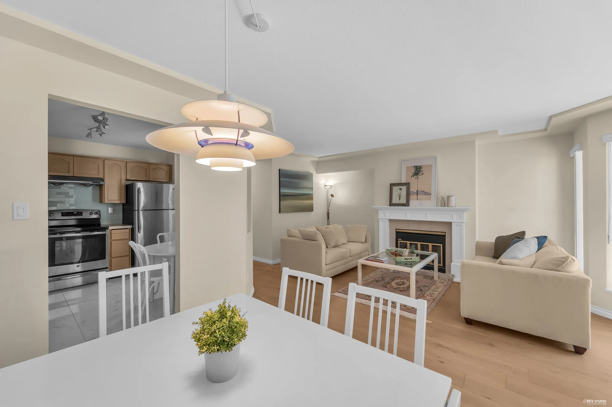 From the dining table toward the fireplace, kitchen at left