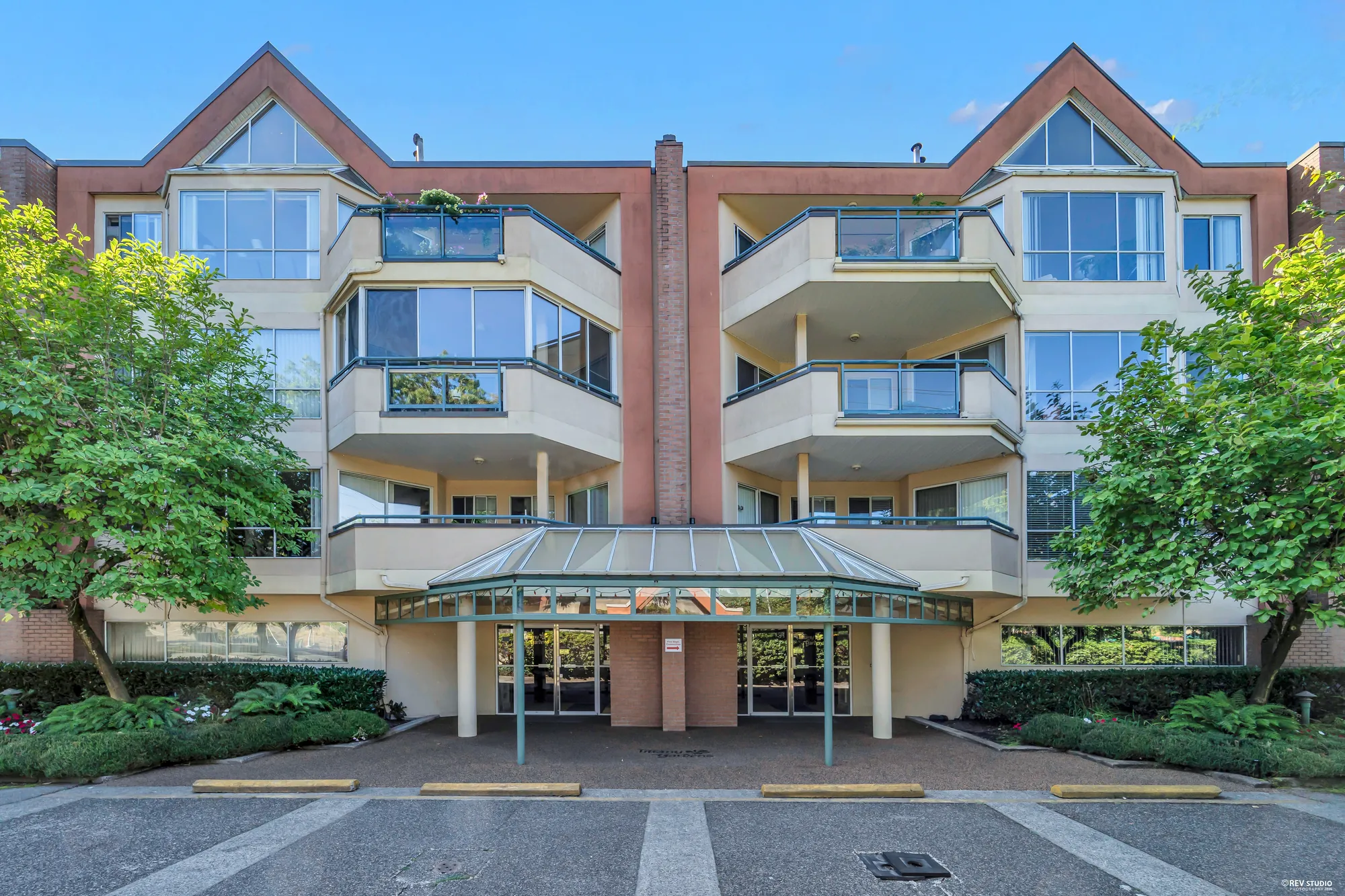 Tiffany Gardens from Lansdowne Road: brick and stucco, balconies, mature trees